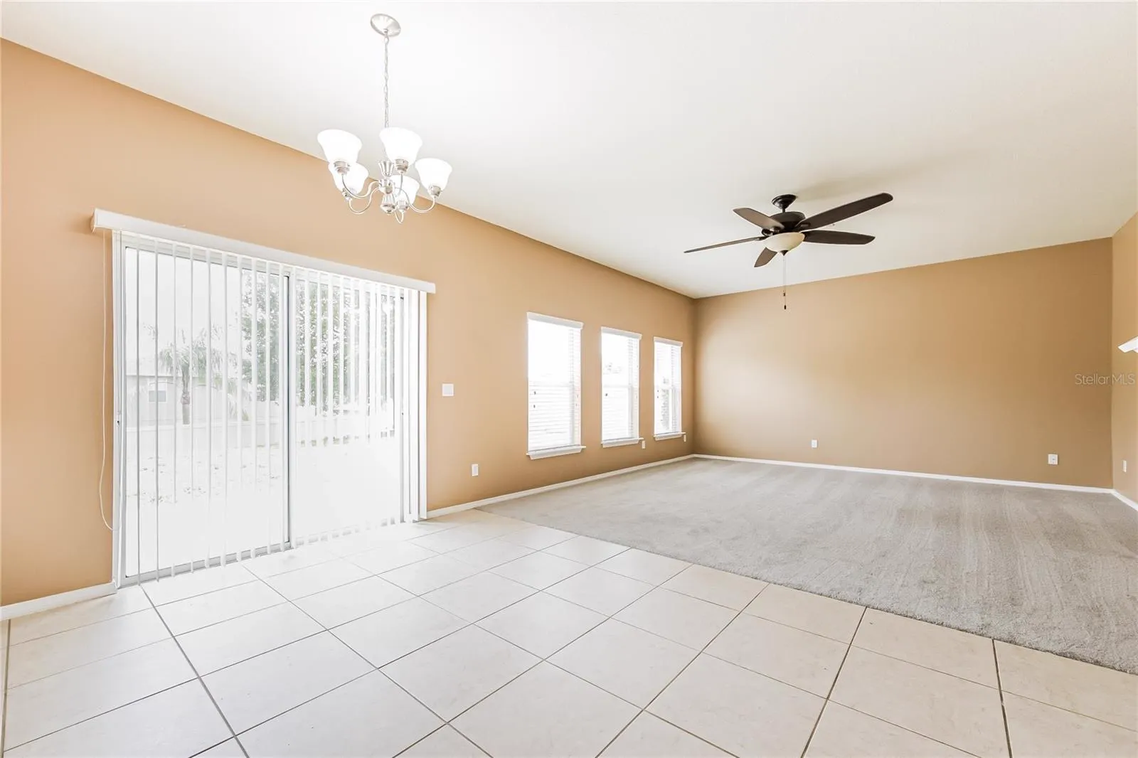 Dining and living area at the Cheval Street home in Mount Dora, Florida, with sliding glass doors leading to the backyard