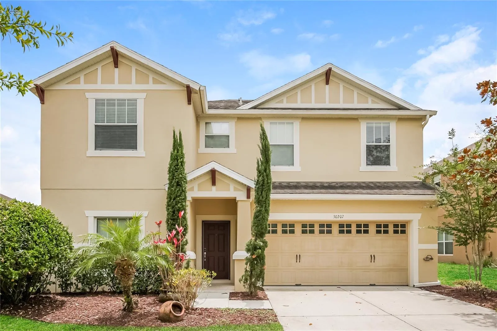 Front exterior of the Cheval Street home in Mount Dora, Florida, with a two-story craftsman-style facade and attached two-car garage