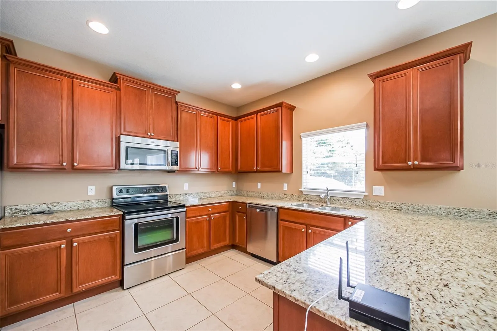Close-up of the kitchen at the Cheval Street home in Mount Dora, Florida, featuring granite countertops and stainless steel appliances