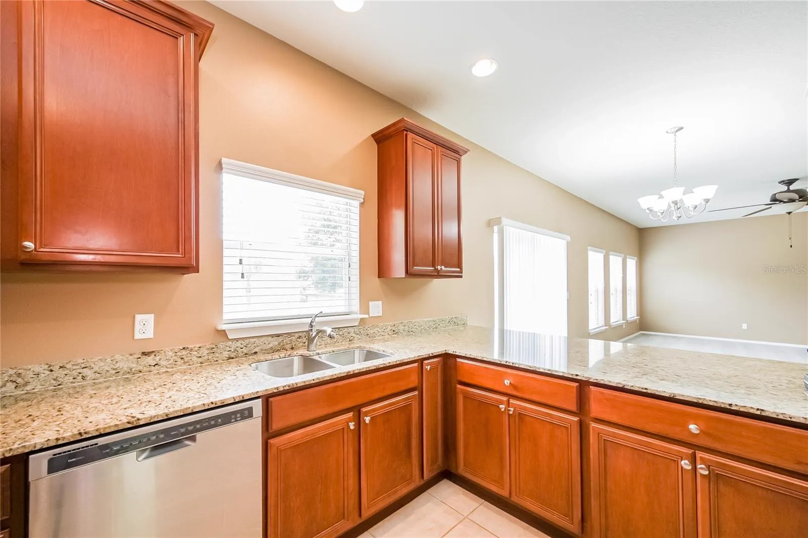 Kitchen at the Cheval Street home in Mount Dora, Florida, with granite countertops and a view into the dining area