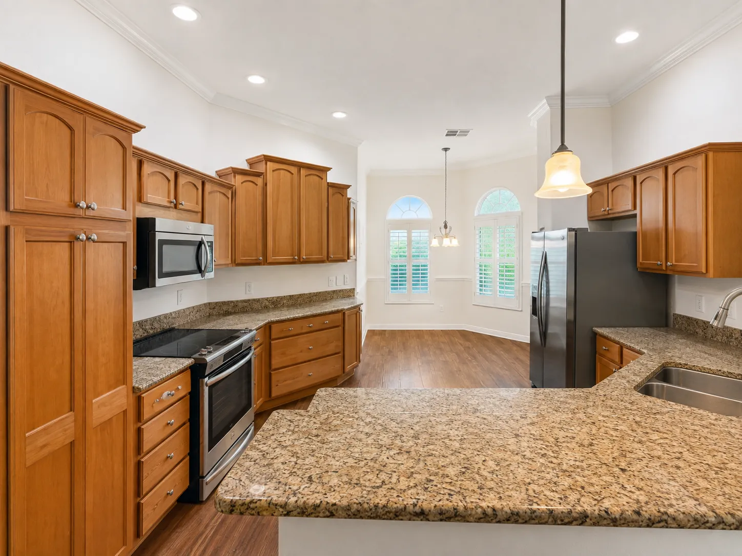 Kitchen with granite countertops and wood cabinetry at 2542 Flintshire Ave