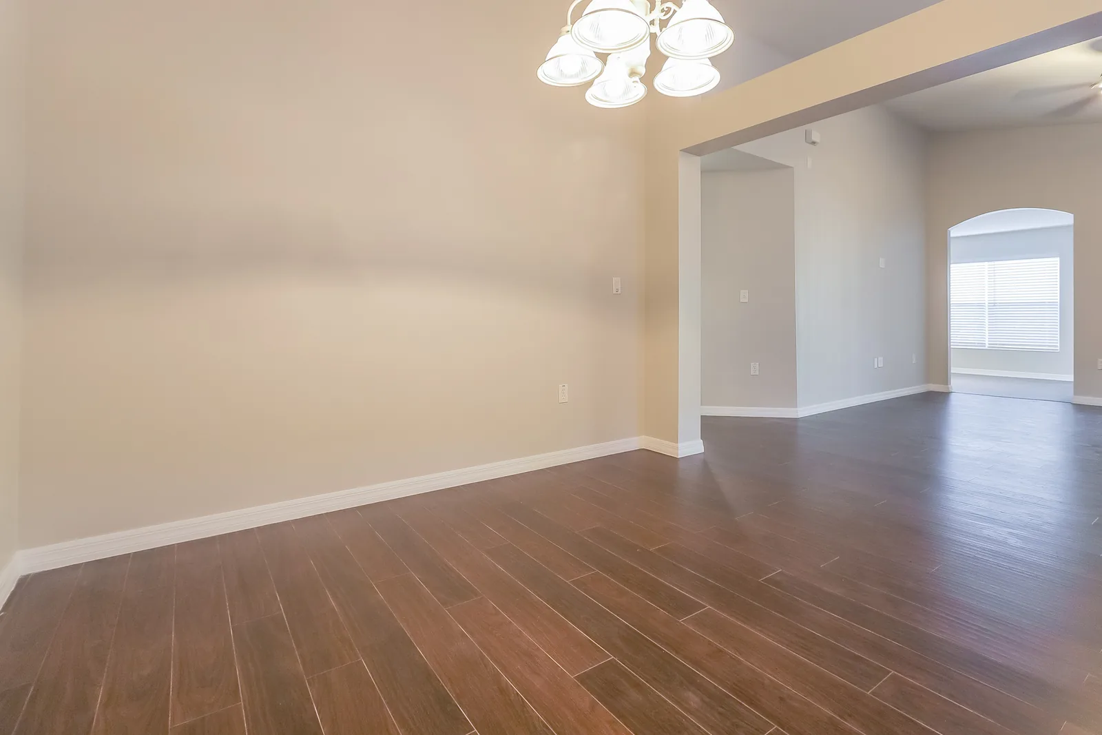 Dining room at the Tee Shot Drive home with a chandelier and an open sightline into the living room